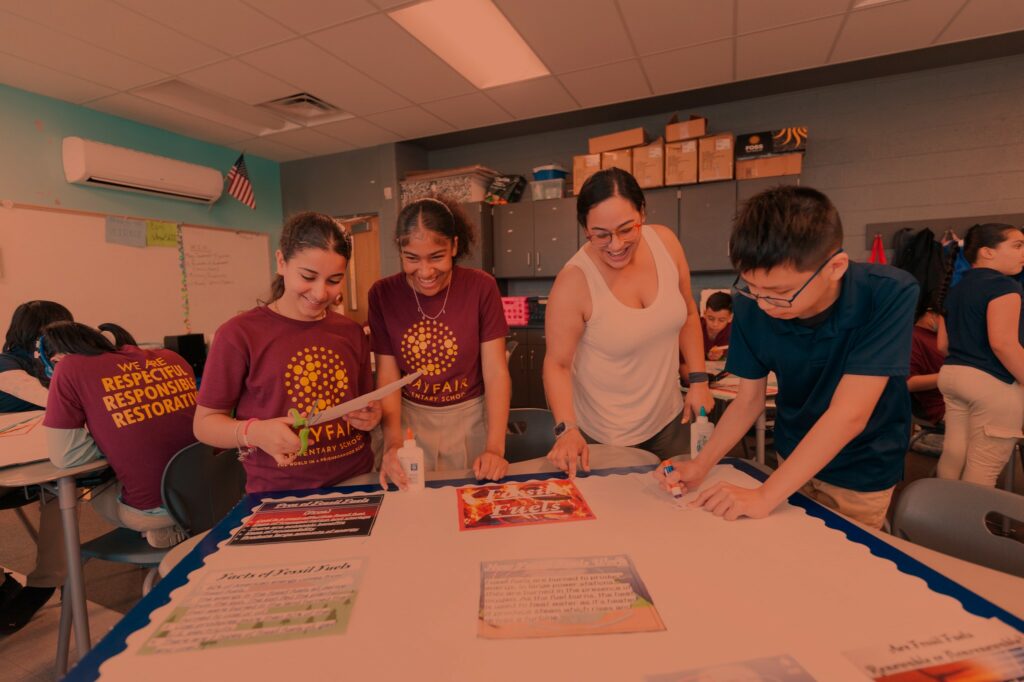 Science teacher leading 3 middle school students through a group activity