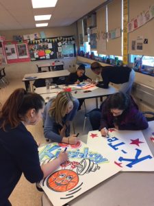 Health & Sciences teachers making posters for the March Madness finals