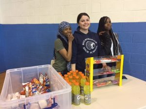 Mrs. Verica and girls selling snacks at March Madness Final
