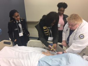 Students learning to draw blood at Drexel Sim Lab