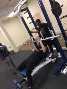 Kinesiology students instructing proper lifting techniques
