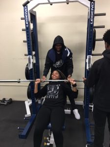 Kinesiology students instructing proper lifting techniques
