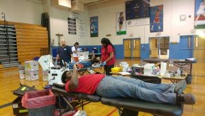Student donating blood at Academies @ Roxborough Blood Drive