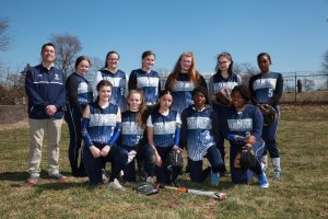 Girls varsity softball team 2019 with coach Mr. Dumsha