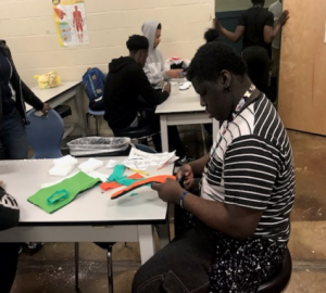 students dissecting sneakers for "Healthy Sneaker" Project