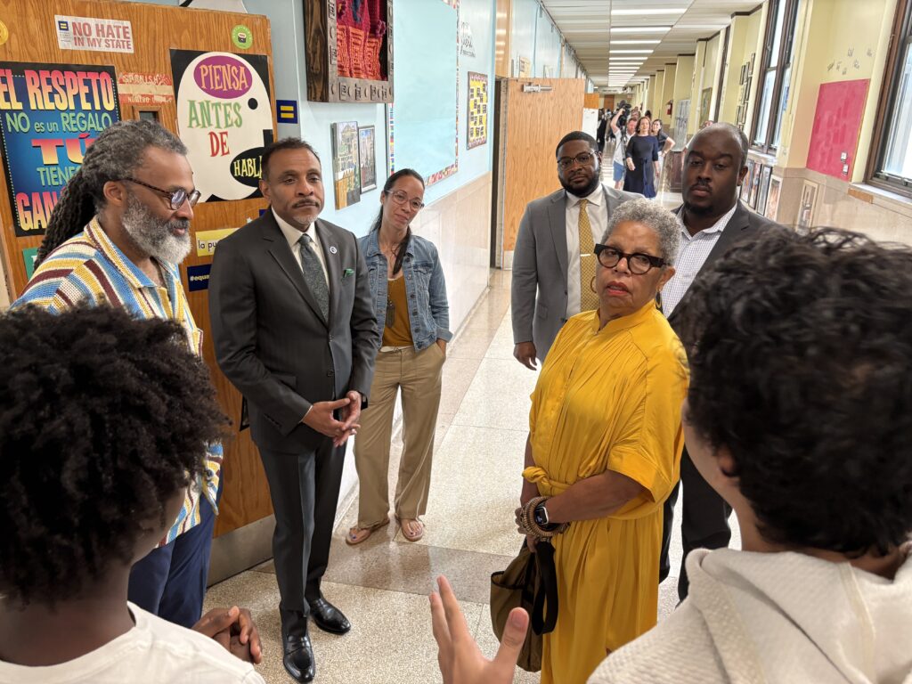 Board members listen as students give tour at SLA Beeber