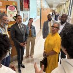 Board members listen as students give tour at SLA Beeber