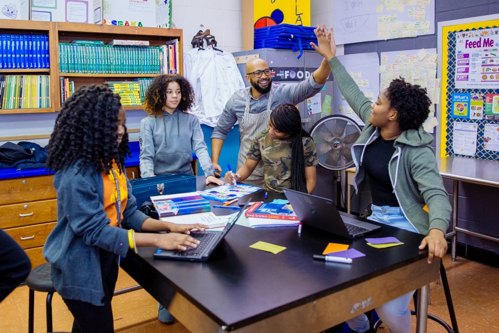 Teacher high fives student