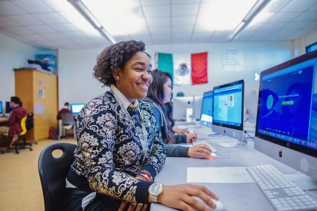 A girl working in a school computer lab