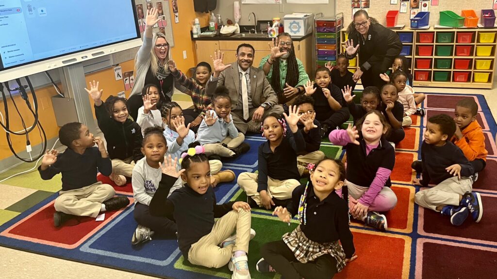 Dr. Watlington on carpet with students