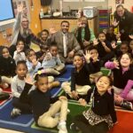 Dr. Watlington on carpet with students