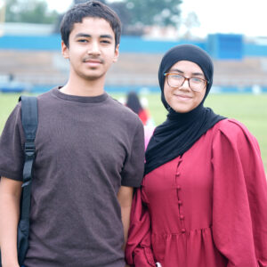 Two students smiling outdoors