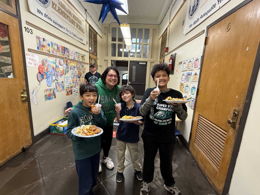 Students with food, smiling in hallway