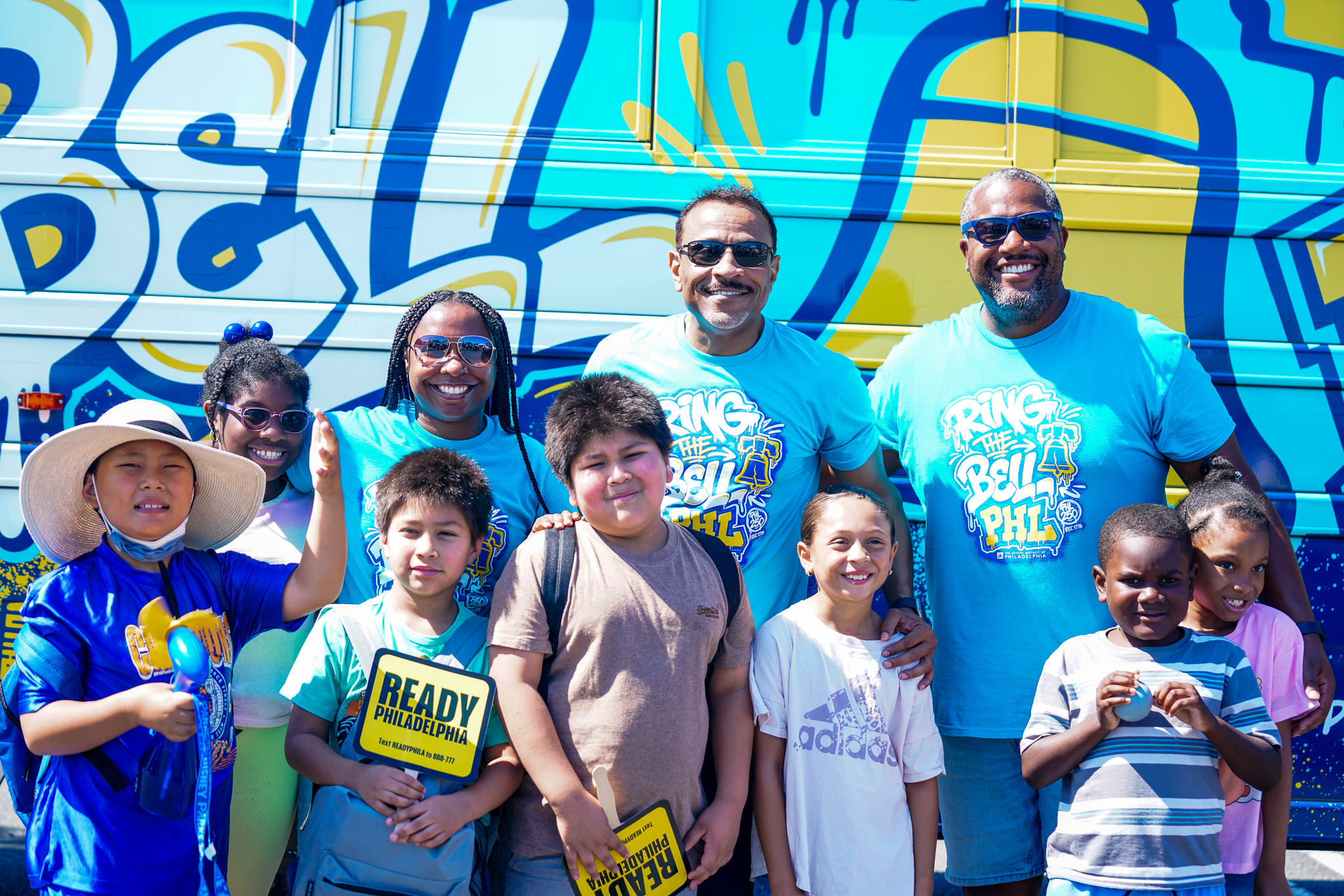 Colorful School District of Philadelphia back-to-school banner featuring graffiti-style text that reads “Ring the Bell PHL” with a Liberty Bell icon. The banner includes the message “Welcome Back!” and announces “School Starts Monday, August 24th” in large teal lettering on a white paint-splash background. The design uses bright teal, yellow, white, and navy colors with a Philadelphia skyline illustration.